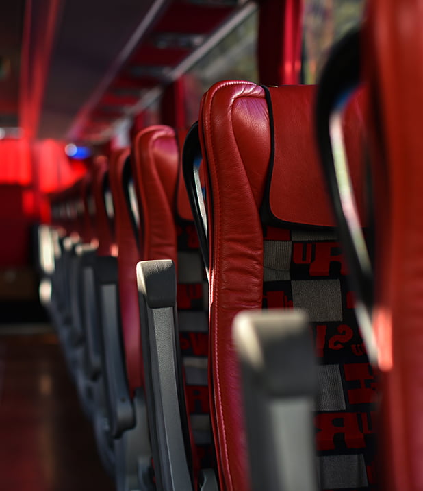 Interior of a bus rental with red seats