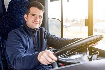 bus driver at the wheel of a bus