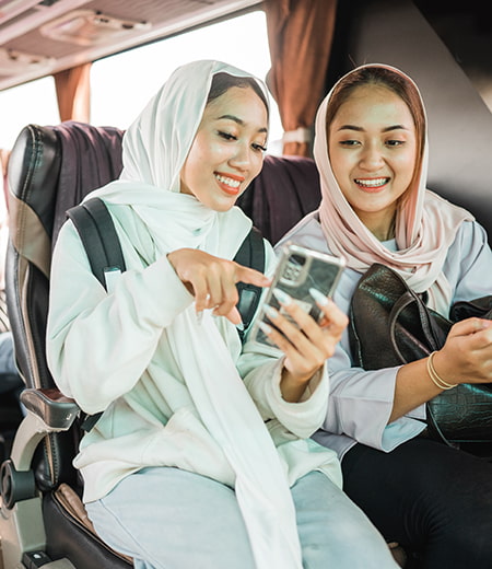 Bus passengers smile and chat in a comfortable bus seat